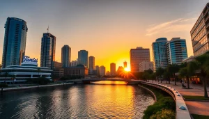 View of Tampa skyline during sunset with vibrant colors and river foreground.